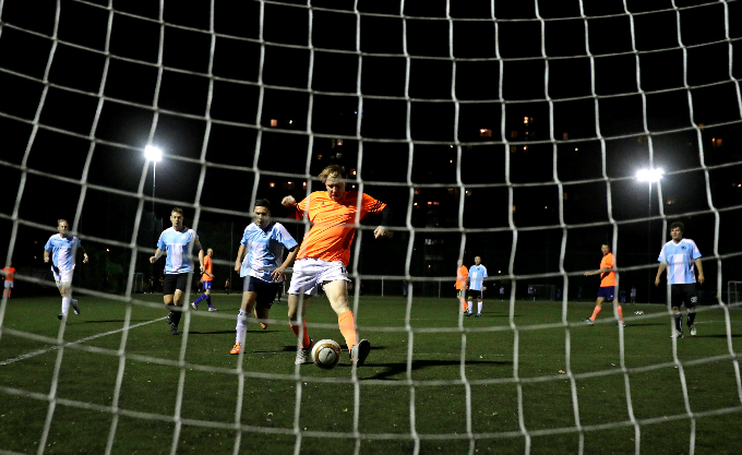 Amateur footballers play a match late in the evening in Prague, Czech Republic.
